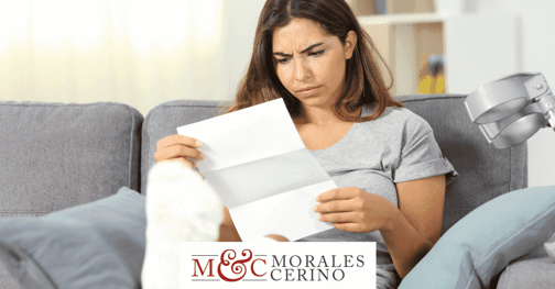 injured woman reading claim denial for workers' compensation